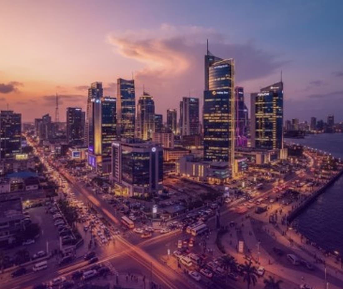 African city skyline at dusk along the waterfront